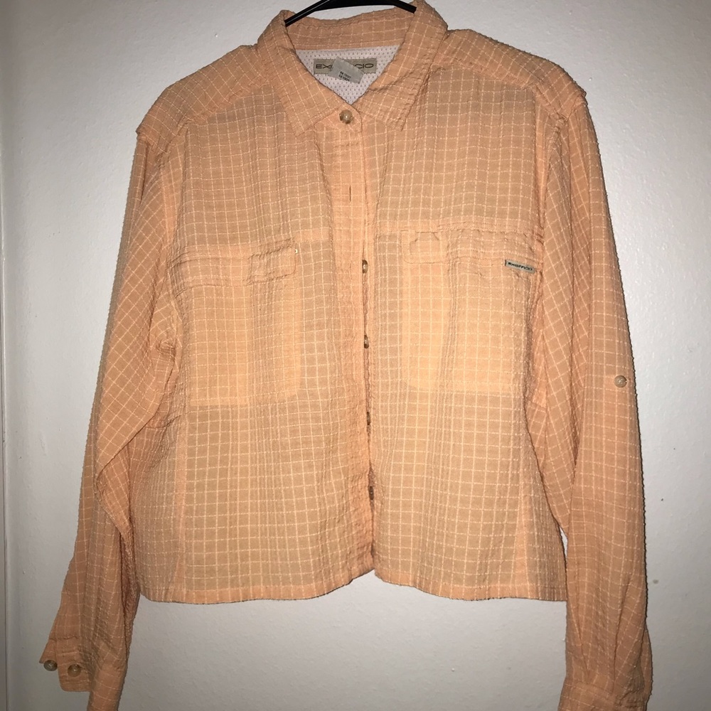 Exofficio peach colored long sleeve cropped top.